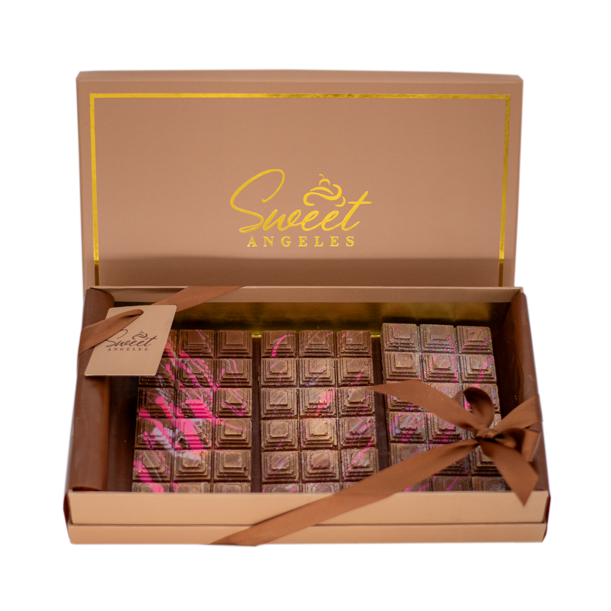 Gift box of artisan chocolate bars with gold and pink accents, ribbon tied, open lid
