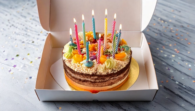 Festive custom birthday cake in a delivery box from Sweet Angeles Los Angeles
