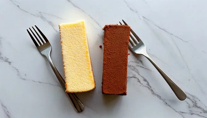 Side-by-side comparison flat-lay on white marble, one slice of cake with smooth glossy buttercream on the left and one with flawless matte f