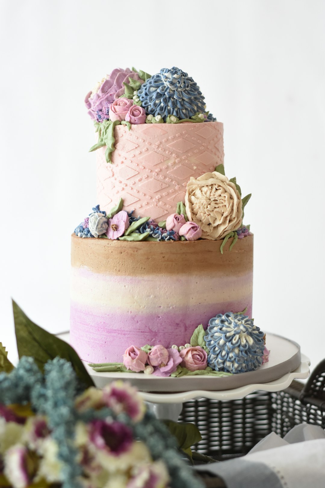 A two tier custom Sweet 16 cake on a cake stand, decorated for a milestone teen birthday party