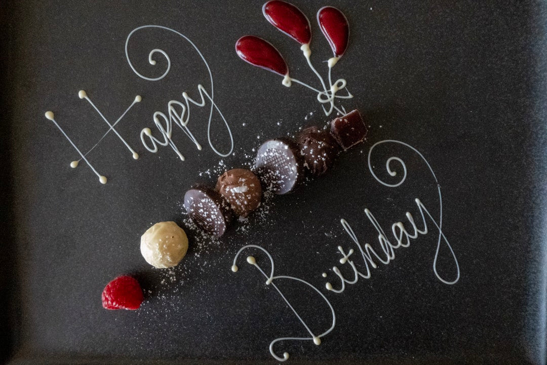 A frosted birthday cake with lit candles, the kind of centerpiece an 18th birthday cake design can build on for a milestone celebration