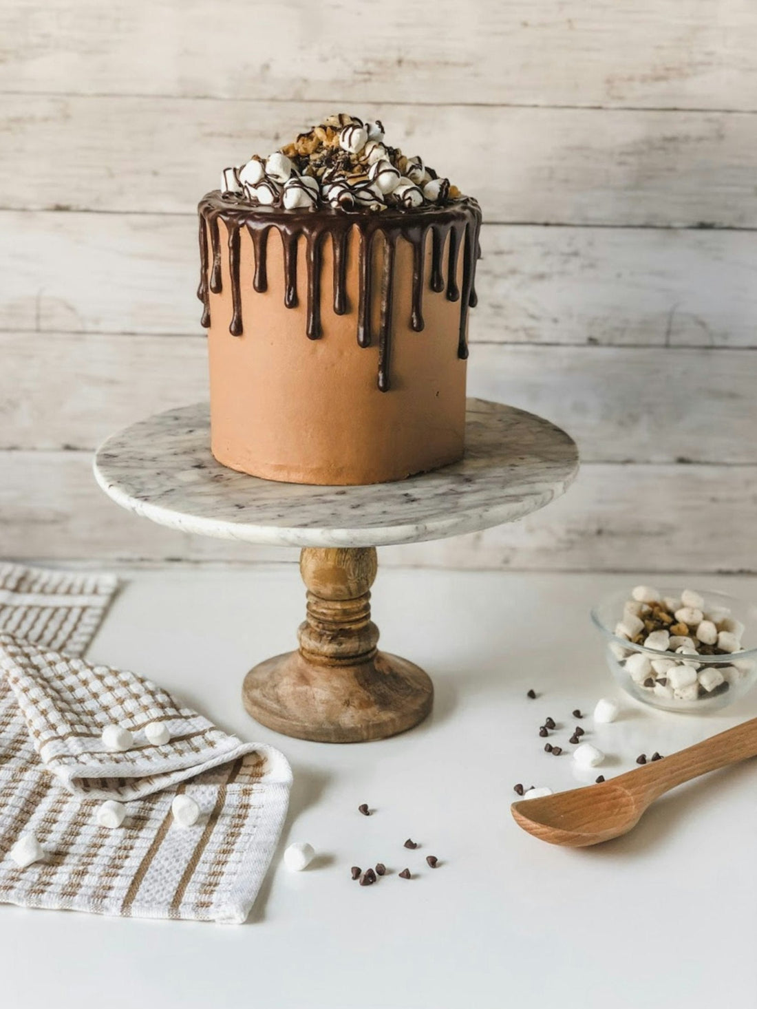 A finished, fully decorated cake on a cake stand, the kind of custom result a cake decorator near me search in Los Angeles is looking for