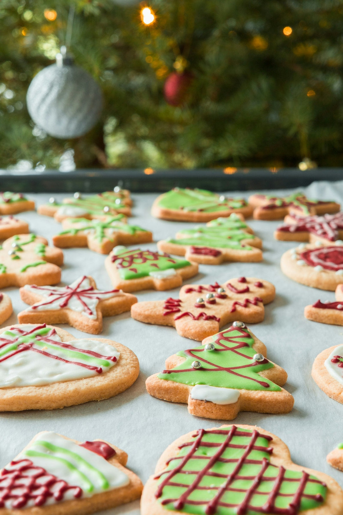 Individually decorated royal icing custom cookies arranged together in a coordinated color palette