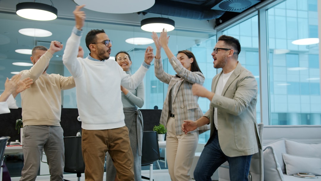 Coworkers celebrating together in a Los Angeles office, the kind of group farewell party moment a going away cake is made for