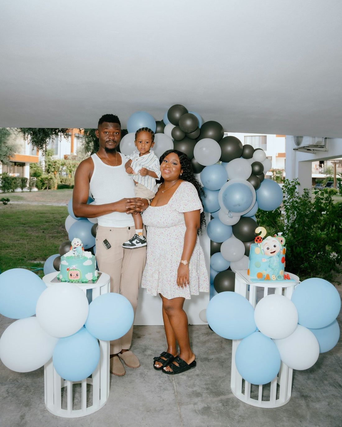 Family celebrating a birthday at home with balloons and a decorated cake, similar to backyard parties in Silver Lake and Los Feliz