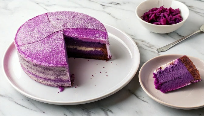 Freshly baked ube cake with a naturally purple crumb from real purple yam and pale cream cheese frosting, sliced to show the inside