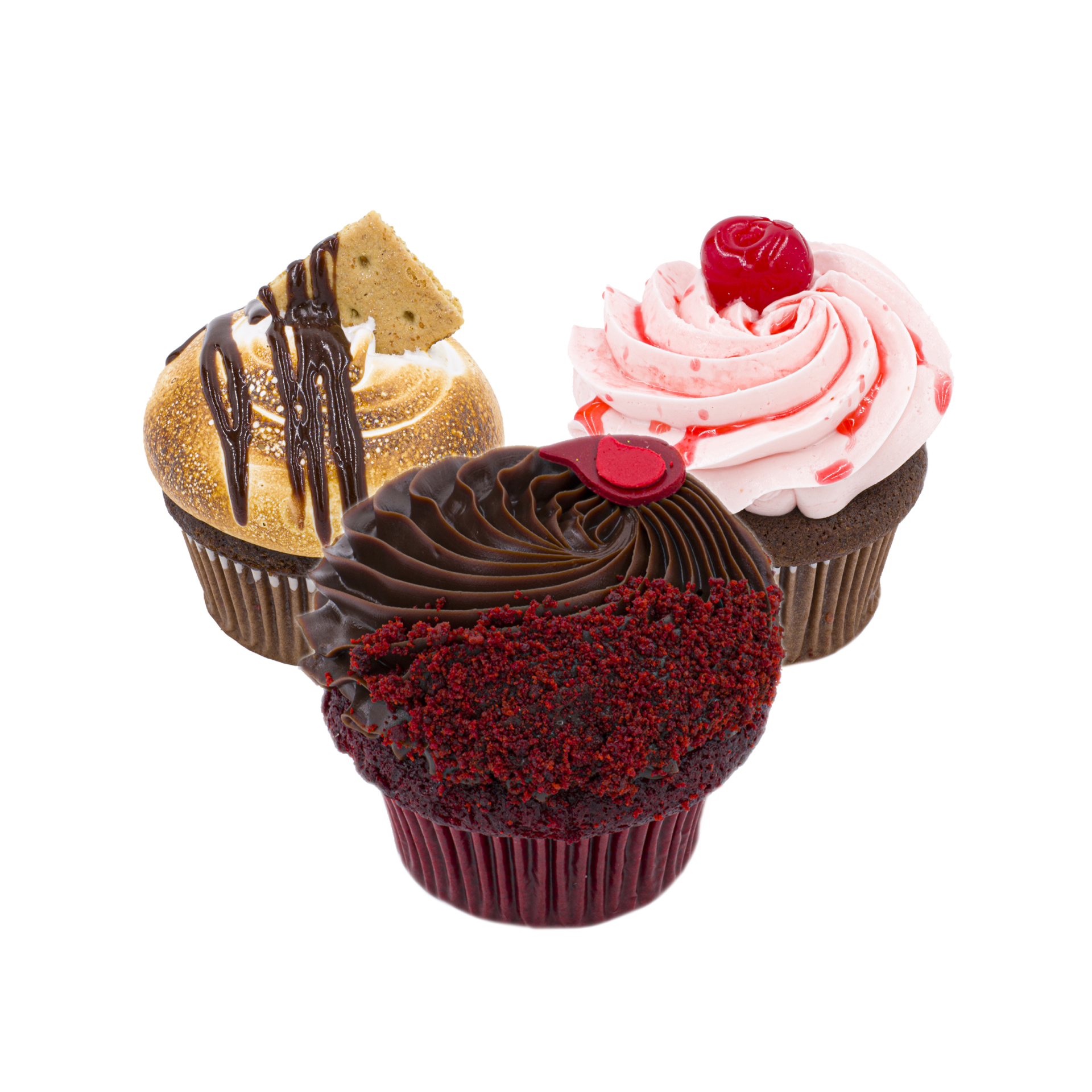Three assorted cupcakes: one with red velvet crumbs and chocolate frosting, one with pink cherry frosting and a cherry on top, and one with toasted meringue, a graham cracker, and chocolate drizzle.