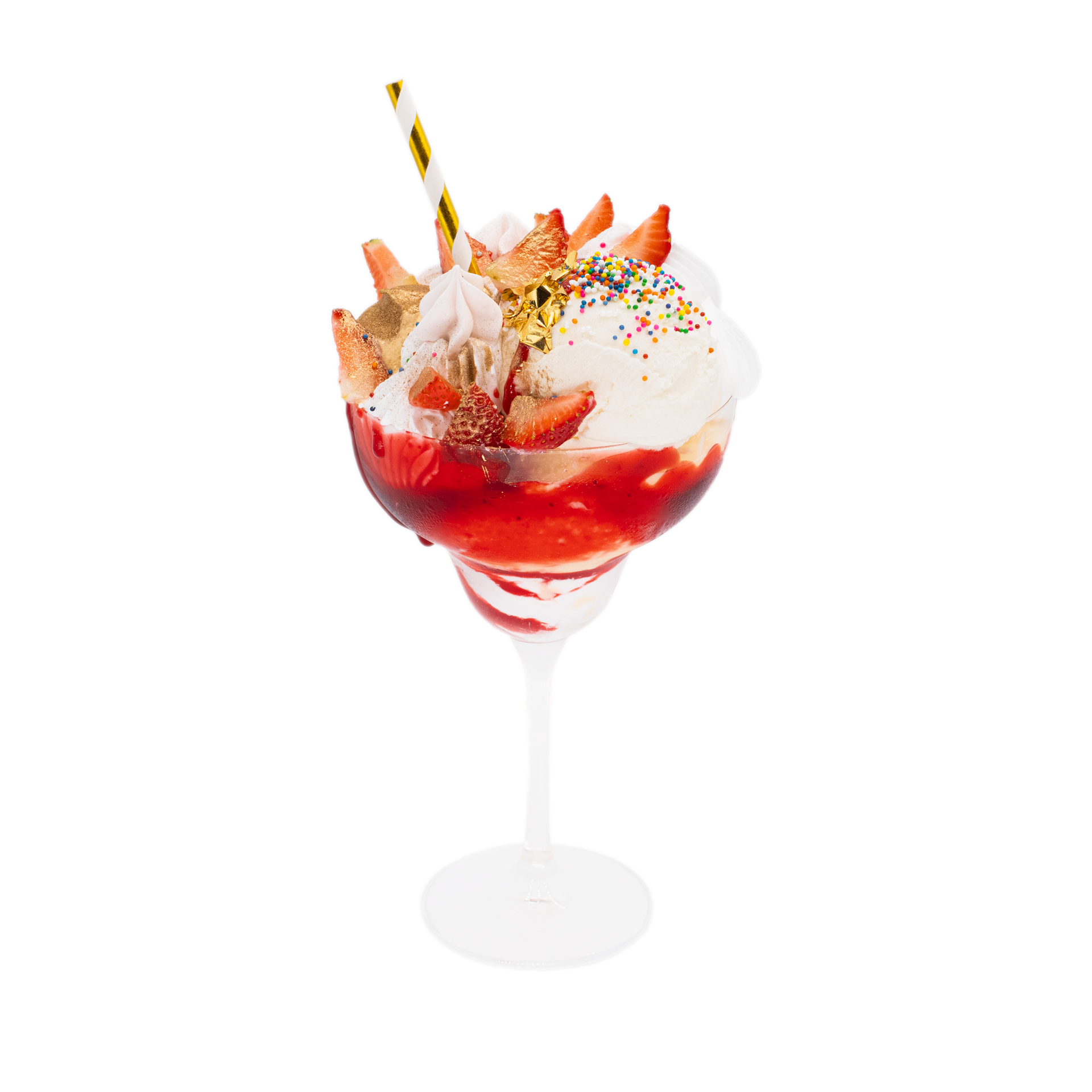 Strawberry sundae with whipped cream, sprinkles, gold leaf and wafer in a dessert glass