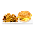 Egg and cheese bagel sandwich with potato chips drizzled with sauce on a white plate