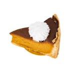 Slice of pumpkin pie with whipped cream on top, golden flaky crust, on white background