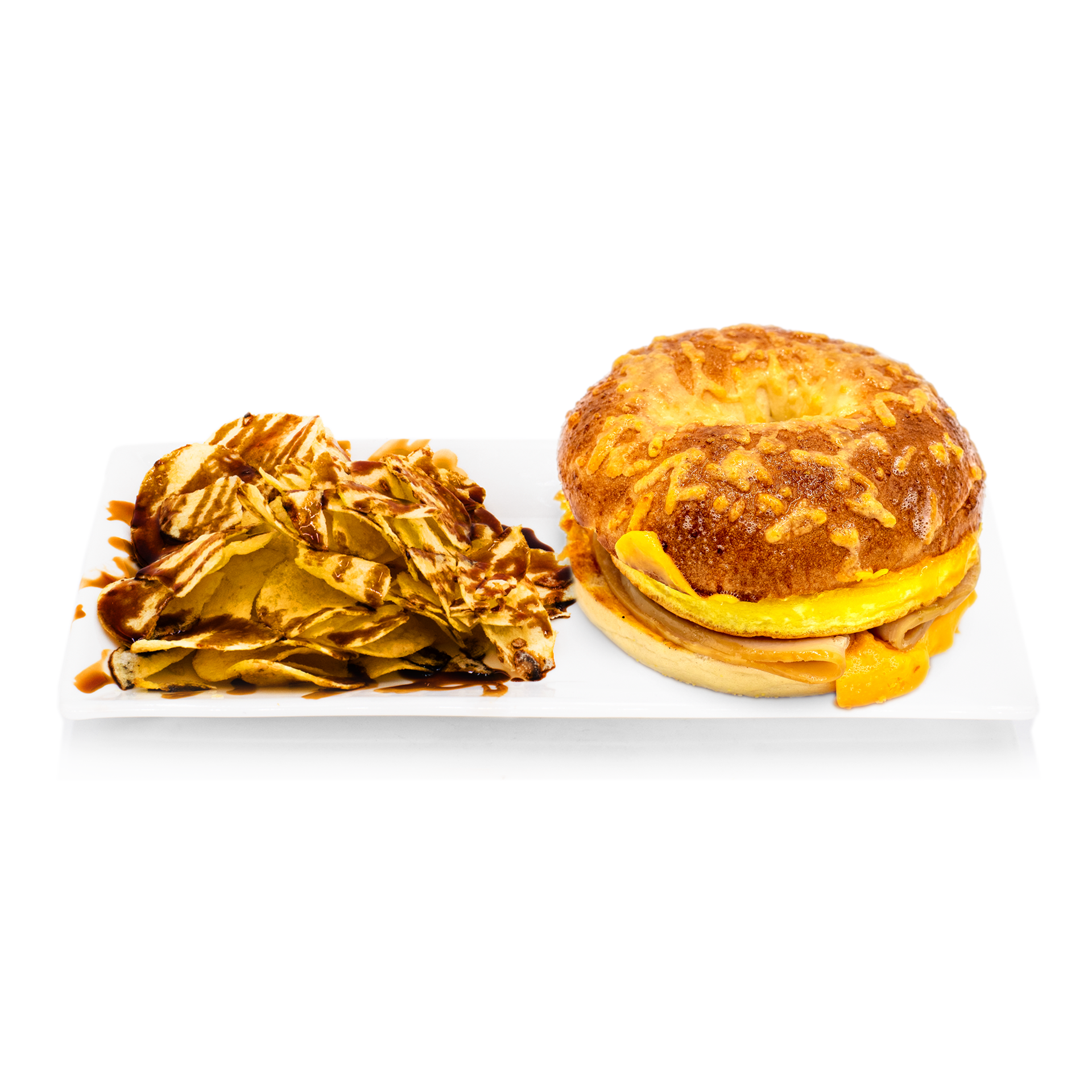 Cheese bagel breakfast sandwich with egg and turkey, served with chips drizzled with sauce