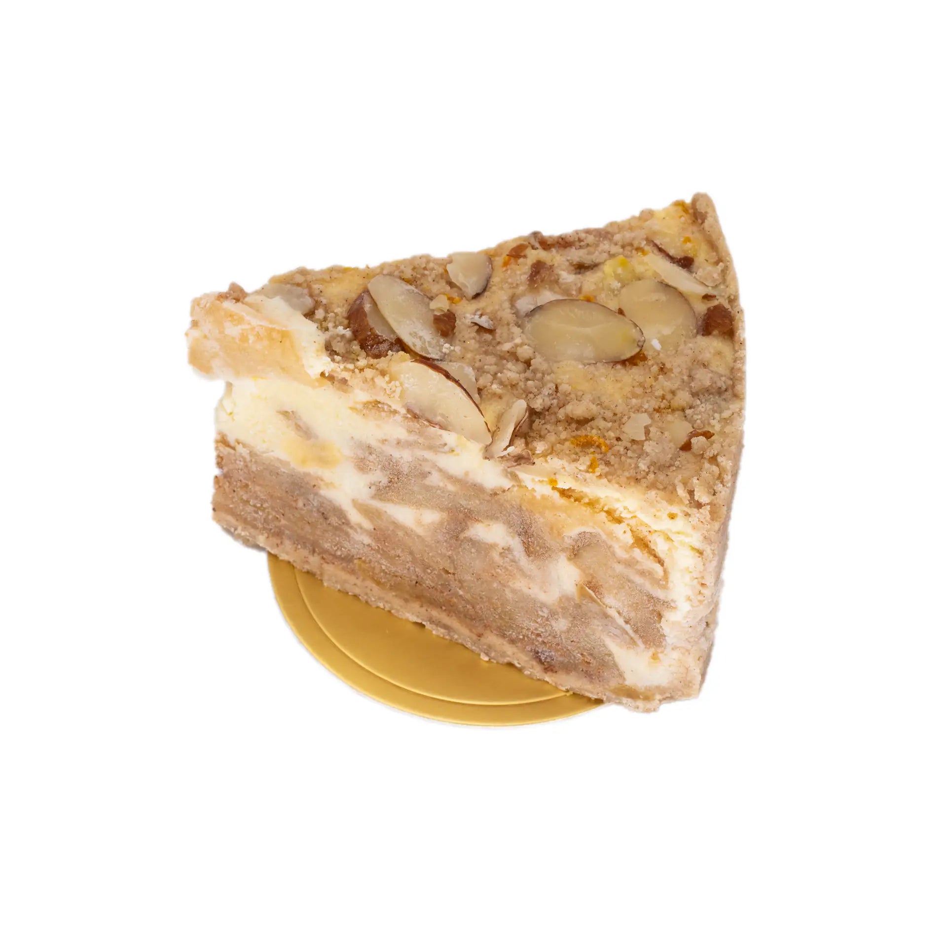 Slice of nut-topped layered cake with cream filling on a gold base, gourmet dessert
