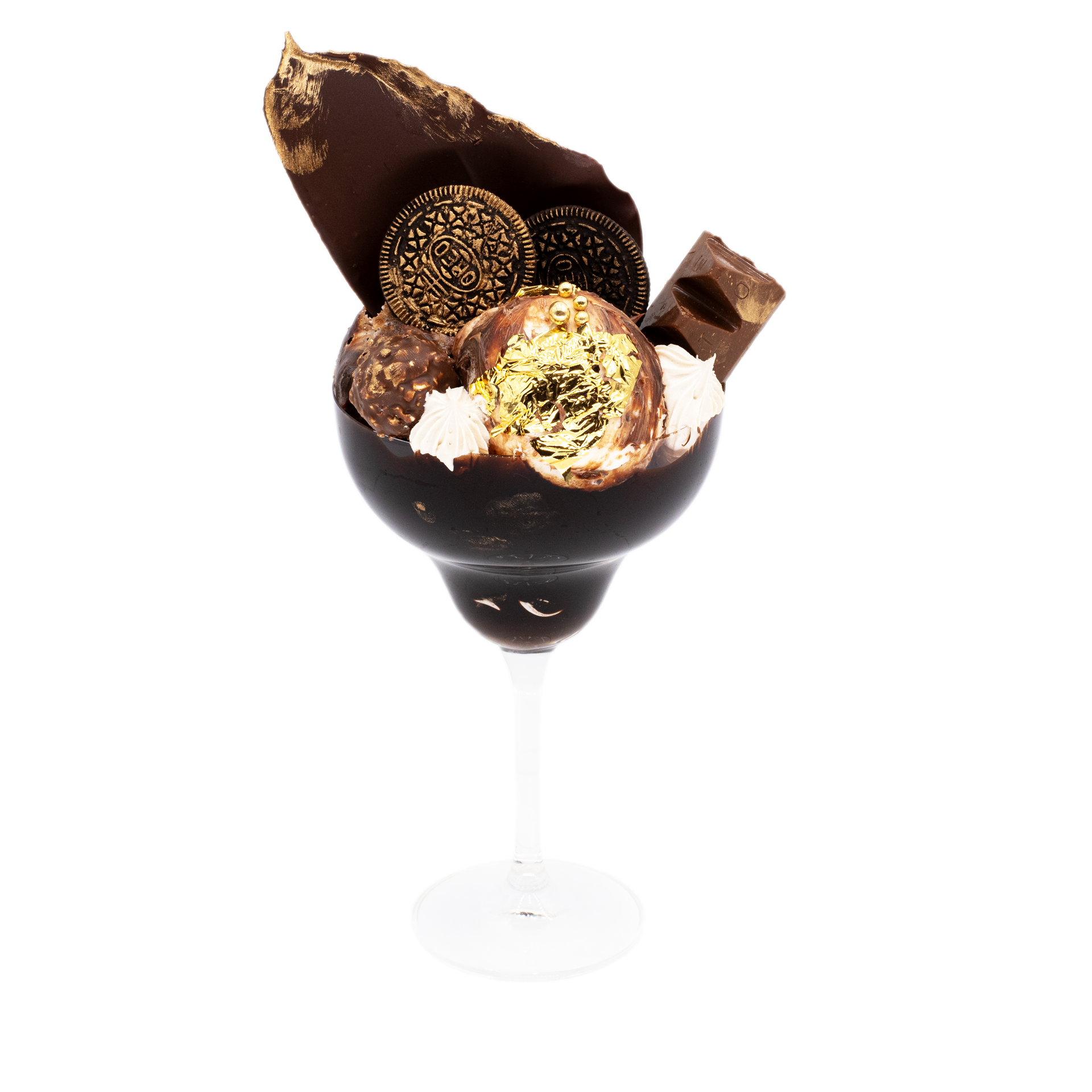 Luxurious gourmet chocolate dessert in a glass with gold leaf, cookies, and whipped cream.