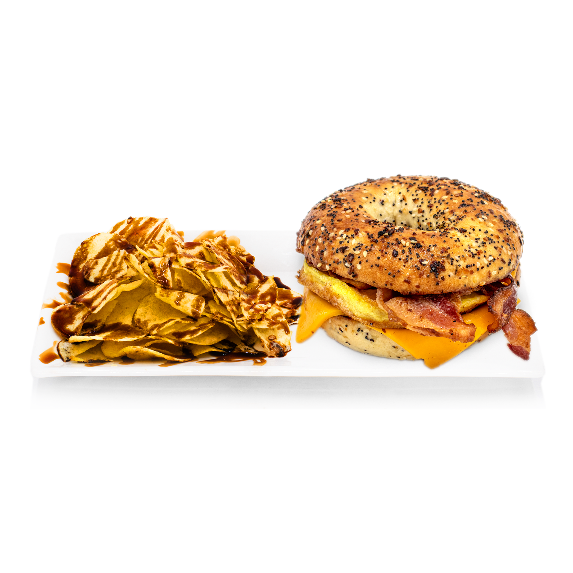 Everything bagel breakfast sandwich with cheddar, bacon, egg and potato chips drizzled with sauce on white plate
