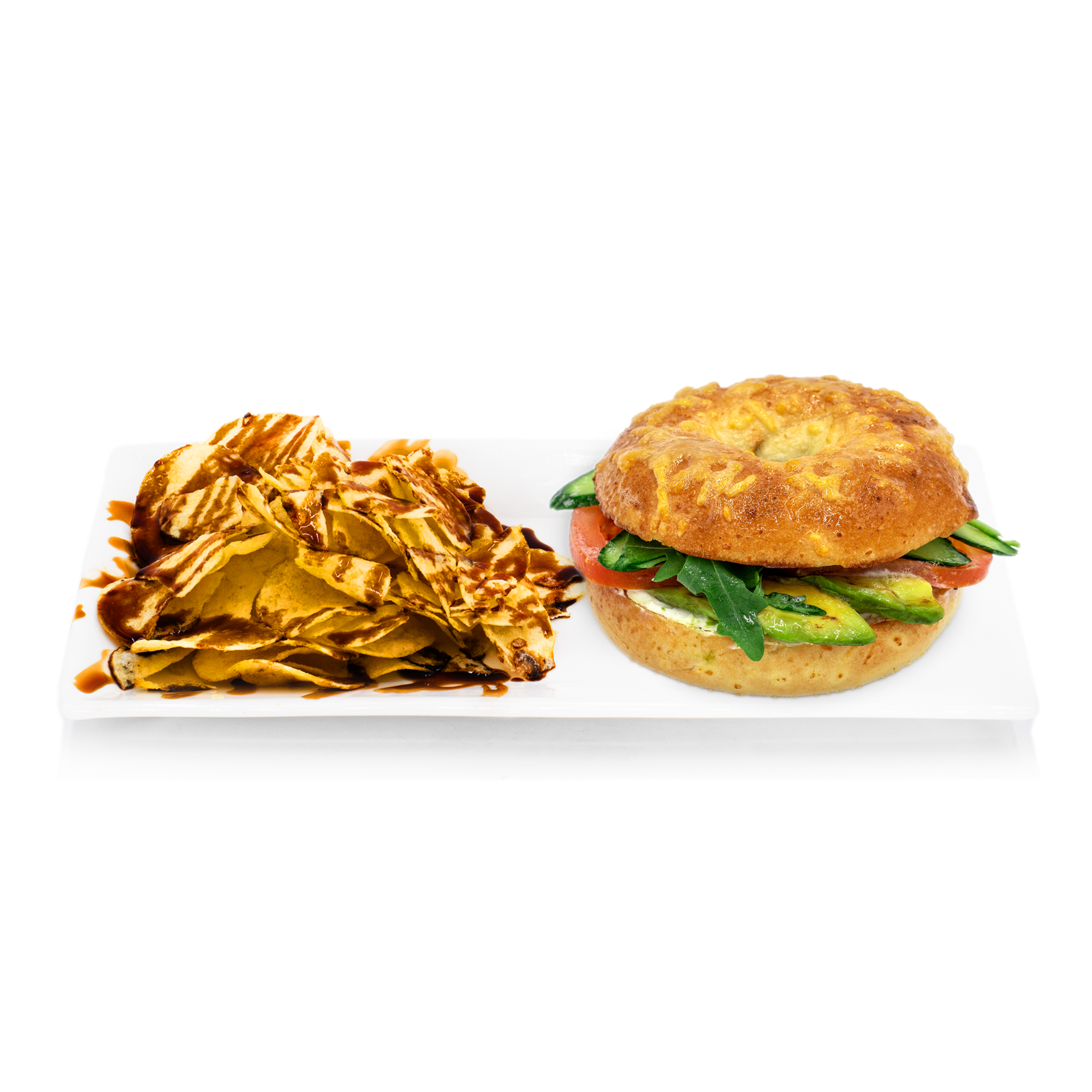 Vegetable sandwich with avocado, tomato, greens on a bun, served with chips and sauce