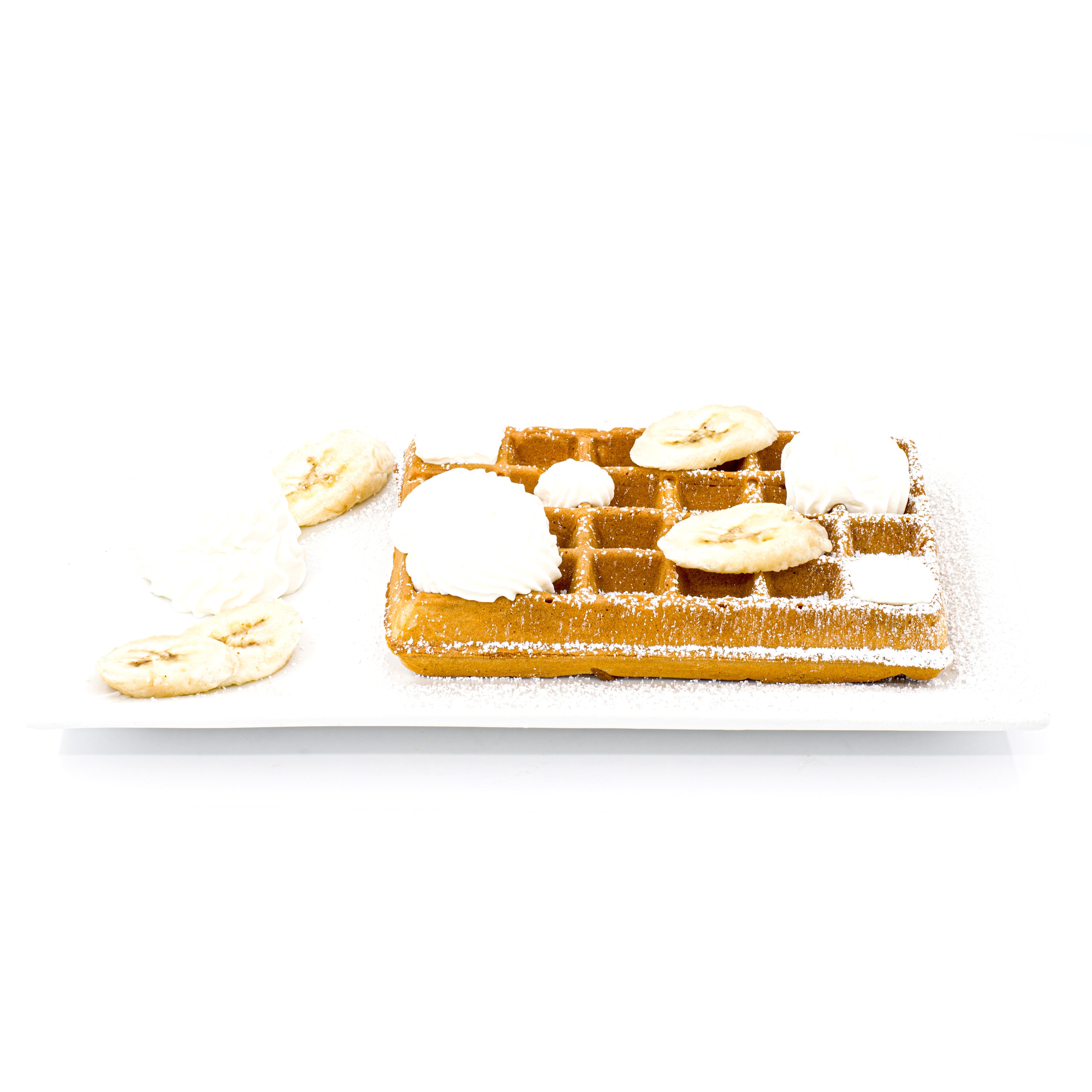 Belgian waffle topped with whipped cream, banana slices, and powdered sugar on a white plate