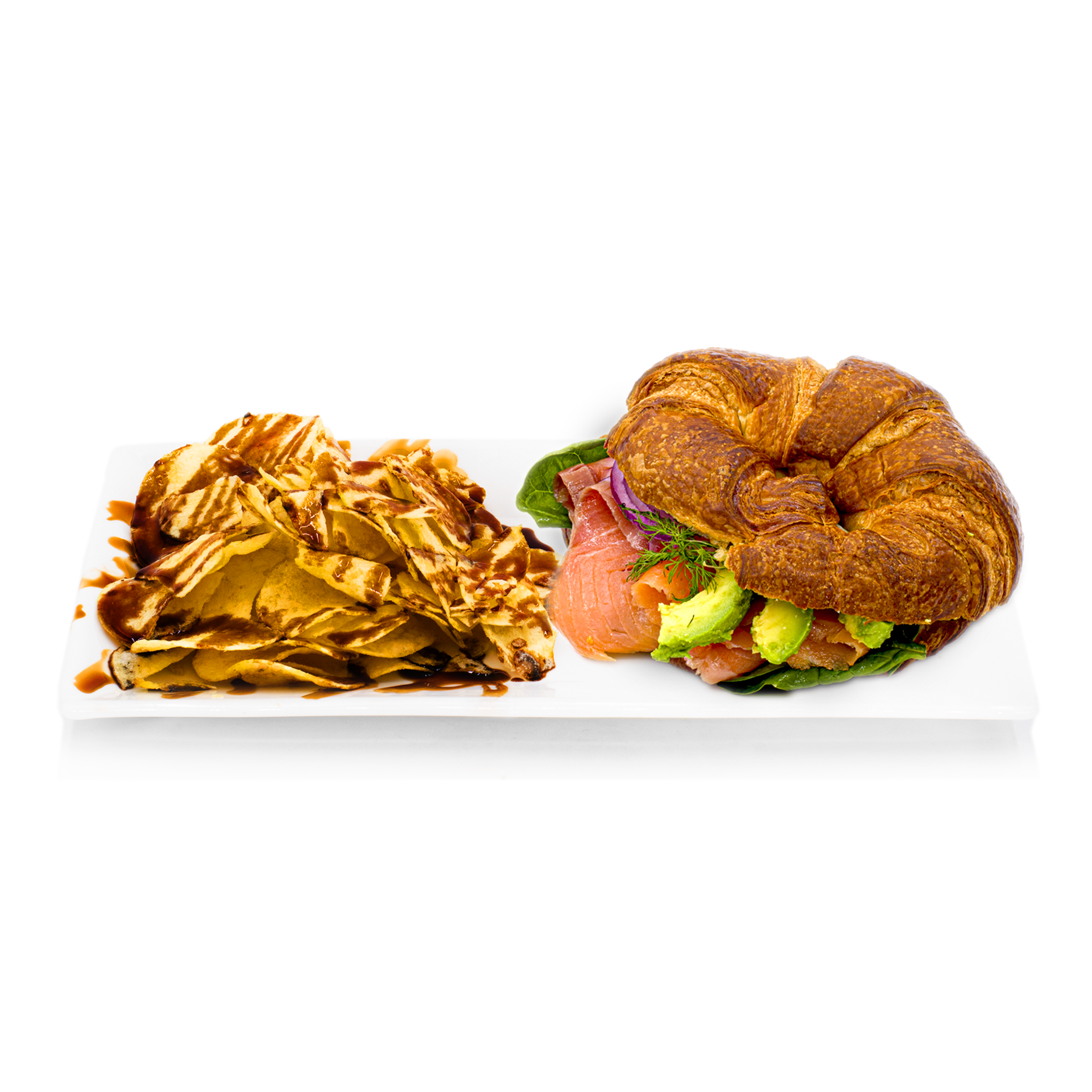 Smoked salmon and avocado croissant sandwich with potato chips on white plate