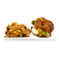 Croissant sandwich with smoked salmon, cucumber, spinach and chips drizzled with sauce on a white plate.
