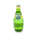 Glass bottle of Perrier sparkling mineral water with yellow label on white background