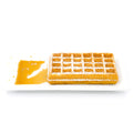 Golden Belgian waffle with powdered sugar and syrup on a white rectangular plate.