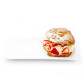Strawberry cream puff pastry dusted with powdered sugar on a white plate