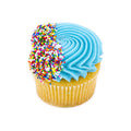 Vanilla cupcake with blue frosting and rainbow sprinkles on top, white background