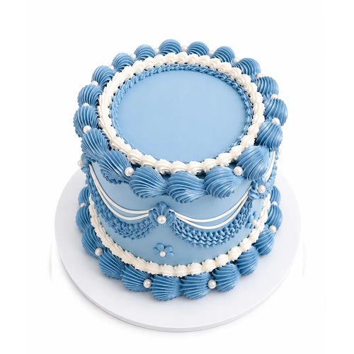 Blue Harmony Cake with elegant light blue and white piped frosting swirls and pearl-like decorations on a white cake board, showcasing a classic custom decorated design.