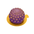 Purple blueberry mousse dessert with gold accents on a round gold tray
