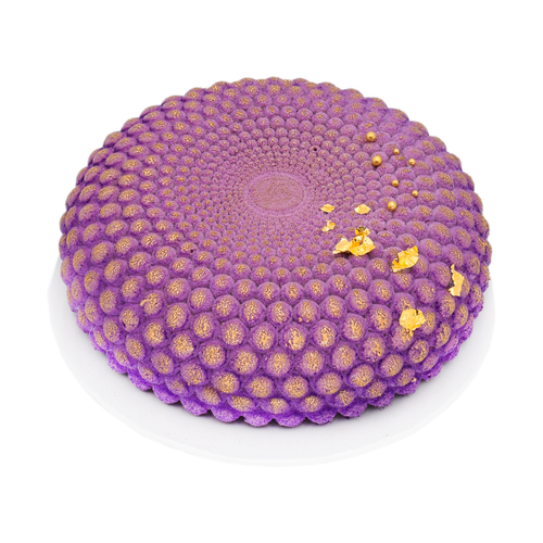 Purple blueberry mousse cake with gold accents on a white plate