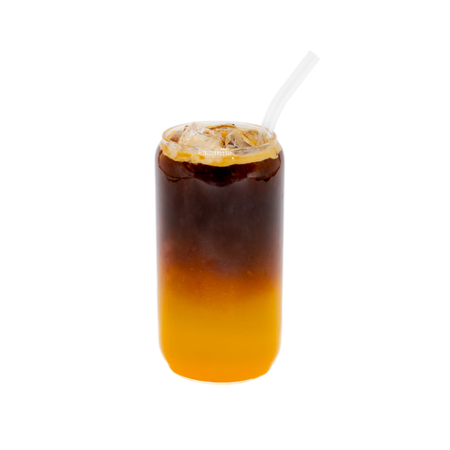 Iced orange coffee in a clear glass with straw, layered orange juice and espresso on white background