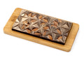 Gourmet dark chocolate bar with whole almonds on a wooden board