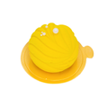 Round yellow lemon mousse dessert with swirl pattern and pearl decorations on gold base