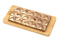 Milk chocolate bar with hazelnuts on a wooden board, geometric pattern, gourmet treat
