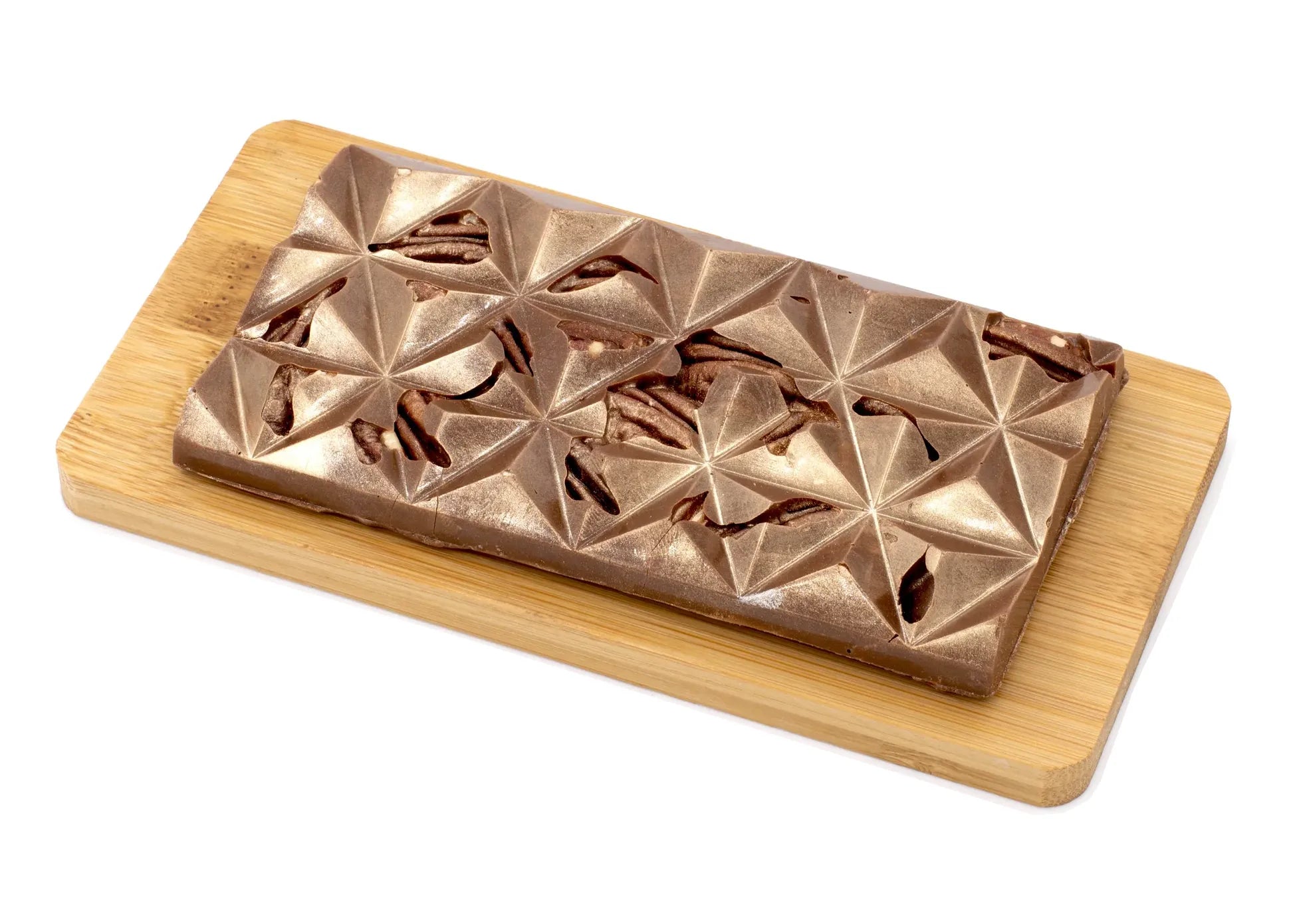 Milk chocolate bar with pecans on a wooden board, geometric surface, gourmet treat
