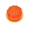 Orange mousse dessert with geometric pattern on gold cake board, gourmet pastry