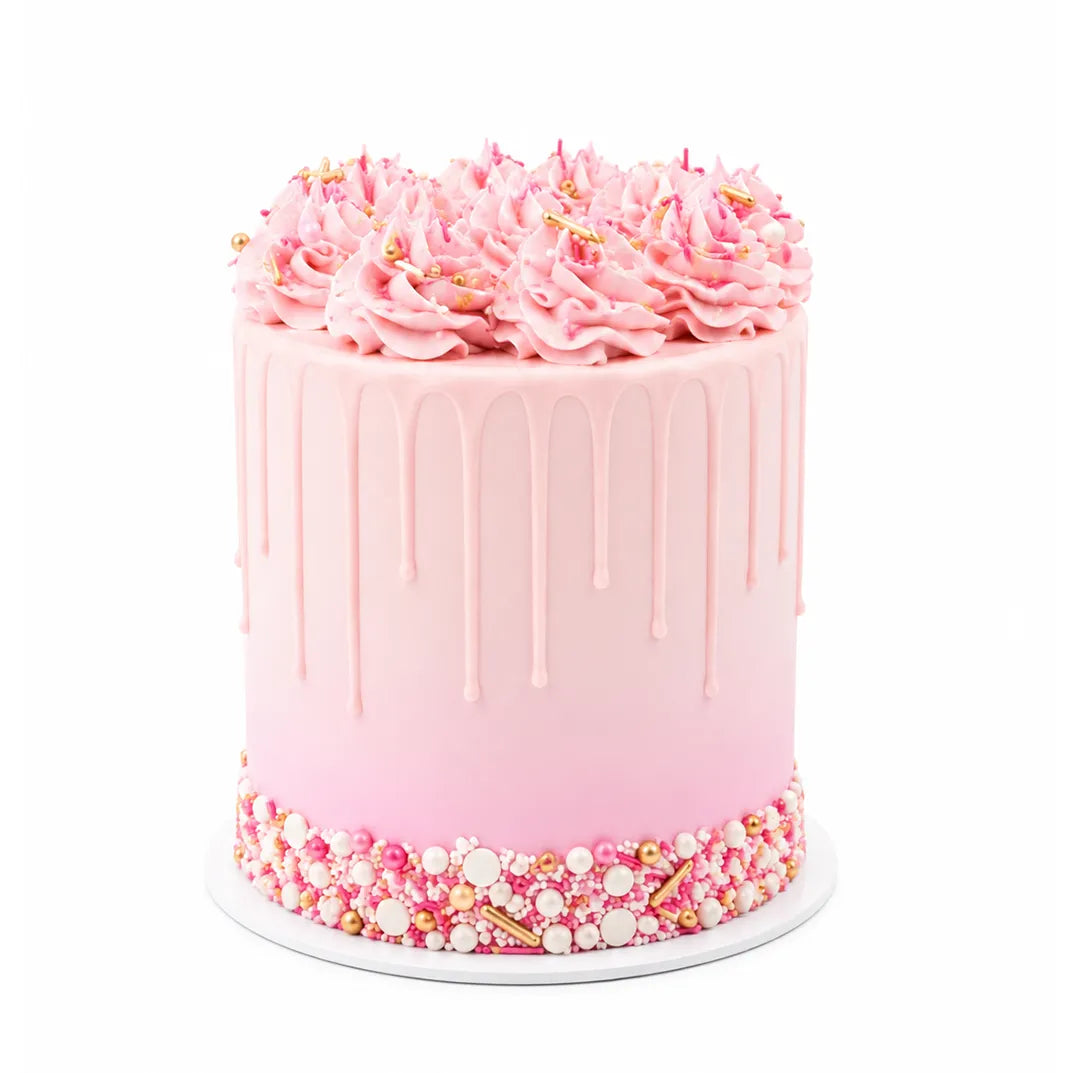 Pink Sparkle Cake with smooth pink ombre icing, delicate drip decoration, topped with swirls of pink frosting and edible gold and white pearls, creating a luxurious custom birthday cake.