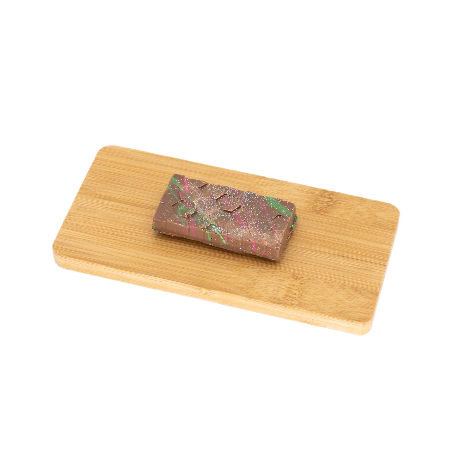 Artisan Dubai pistachio chocolate bar with colorful splatter on bamboo board