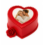 Red Love Story Rose Heart Cake with a custom photo on top, decorated with red edible pearls and a red rose on the side, perfect for romantic celebrations.