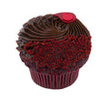 Red velvet cupcake topped with chocolate ganache frosting and red cake crumbs