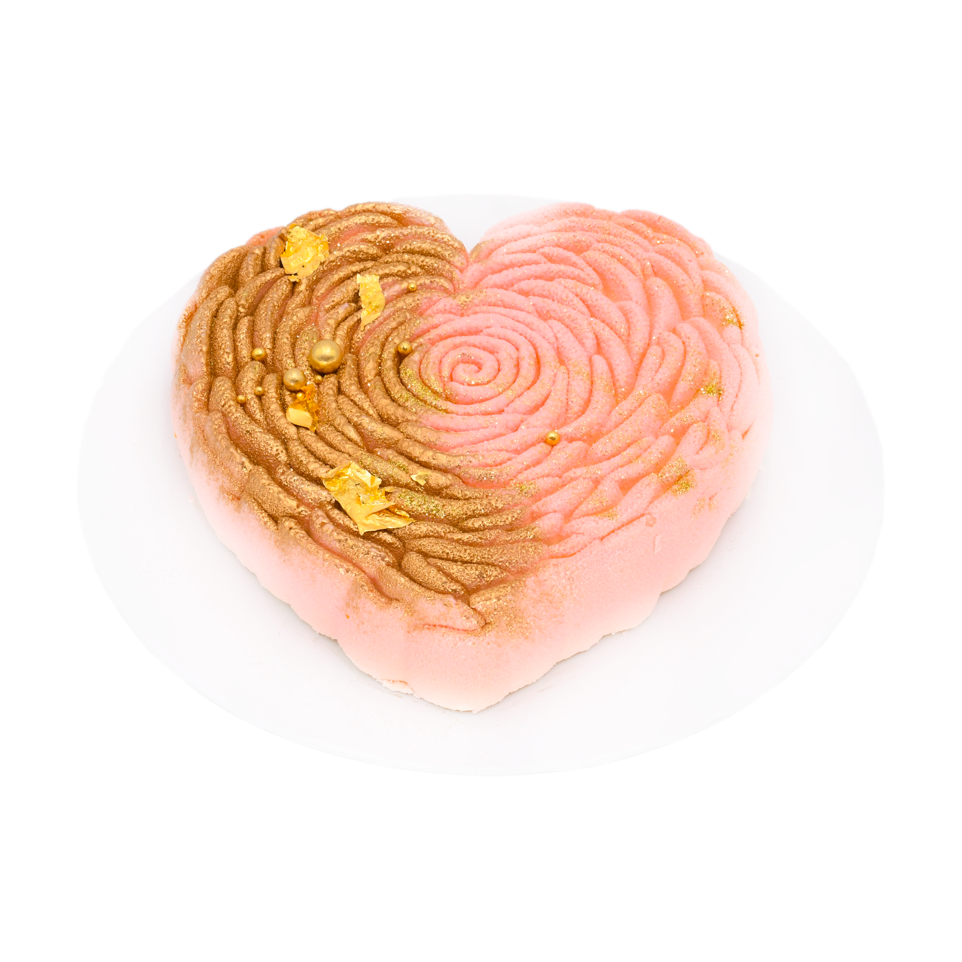 Heart-shaped red velvet pink mousse cake with gold accents on white plate