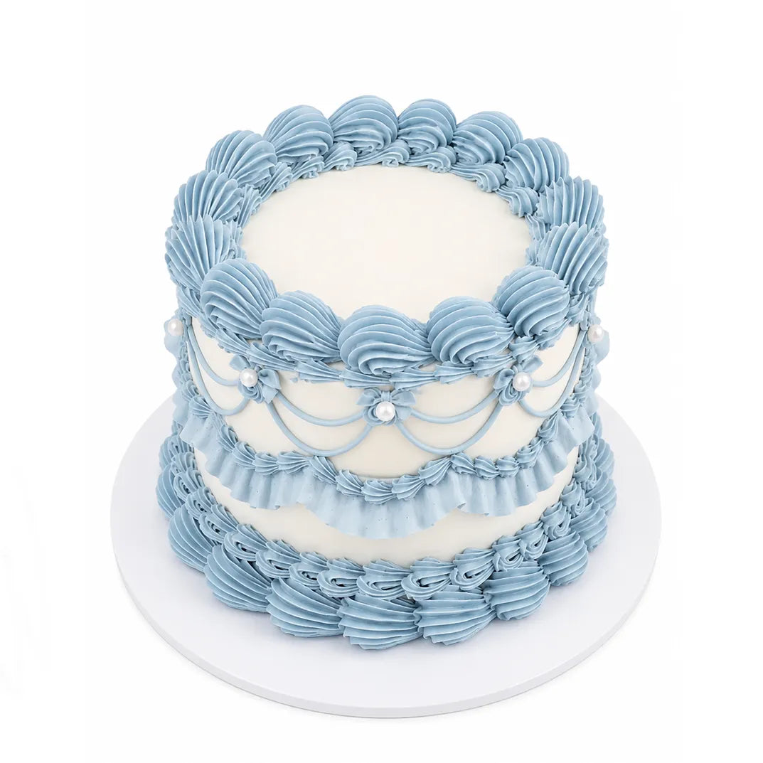 Soft Love Cake featuring elegant light blue piped frosting with pearl accents on a smooth white frosting base, perfect as a custom decorated cake for special occasions.