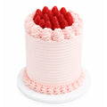 Blush pink ridged strawberry shortcake with hand-piped rosettes and whole fresh strawberries on top — cake delivery at Sweet Angeles Los Angeles