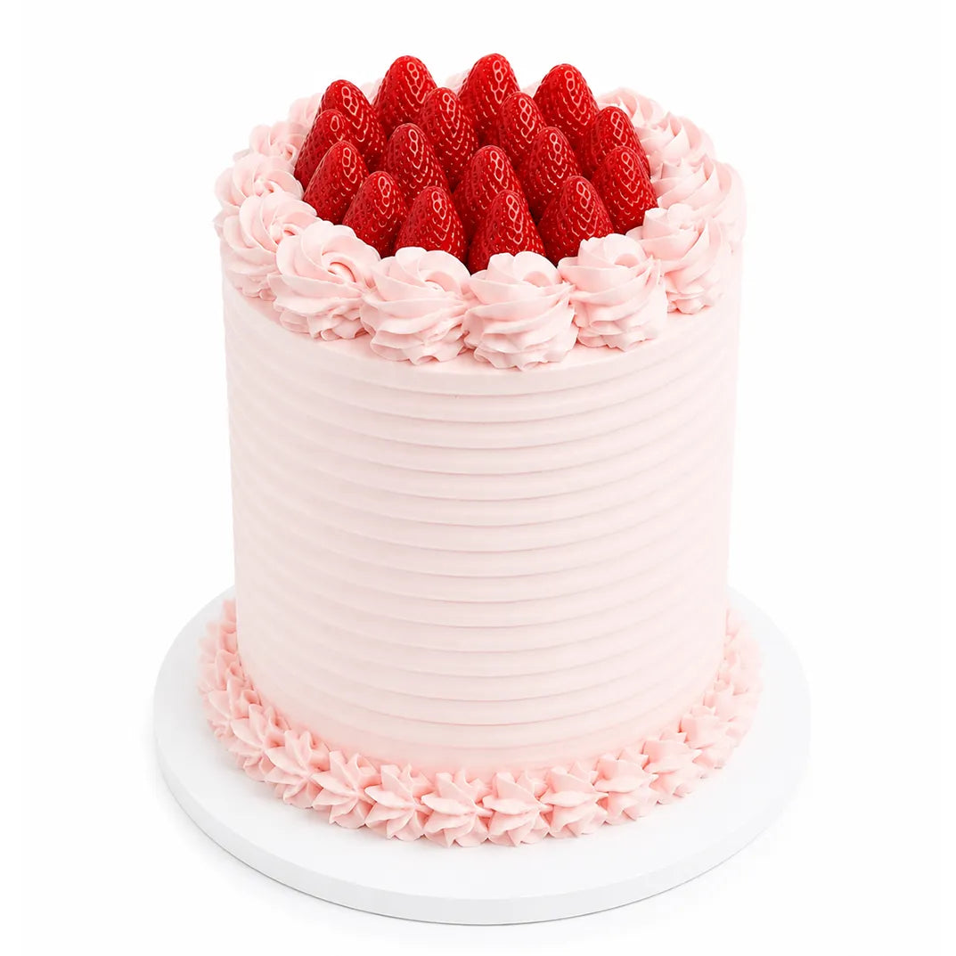 Blush pink ridged strawberry shortcake with hand-piped rosettes and whole fresh strawberries on top — cake delivery at Sweet Angeles Los Angeles