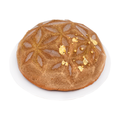 Elegant three chocolate mousse cake with gold leaf and geometric pattern on white plate