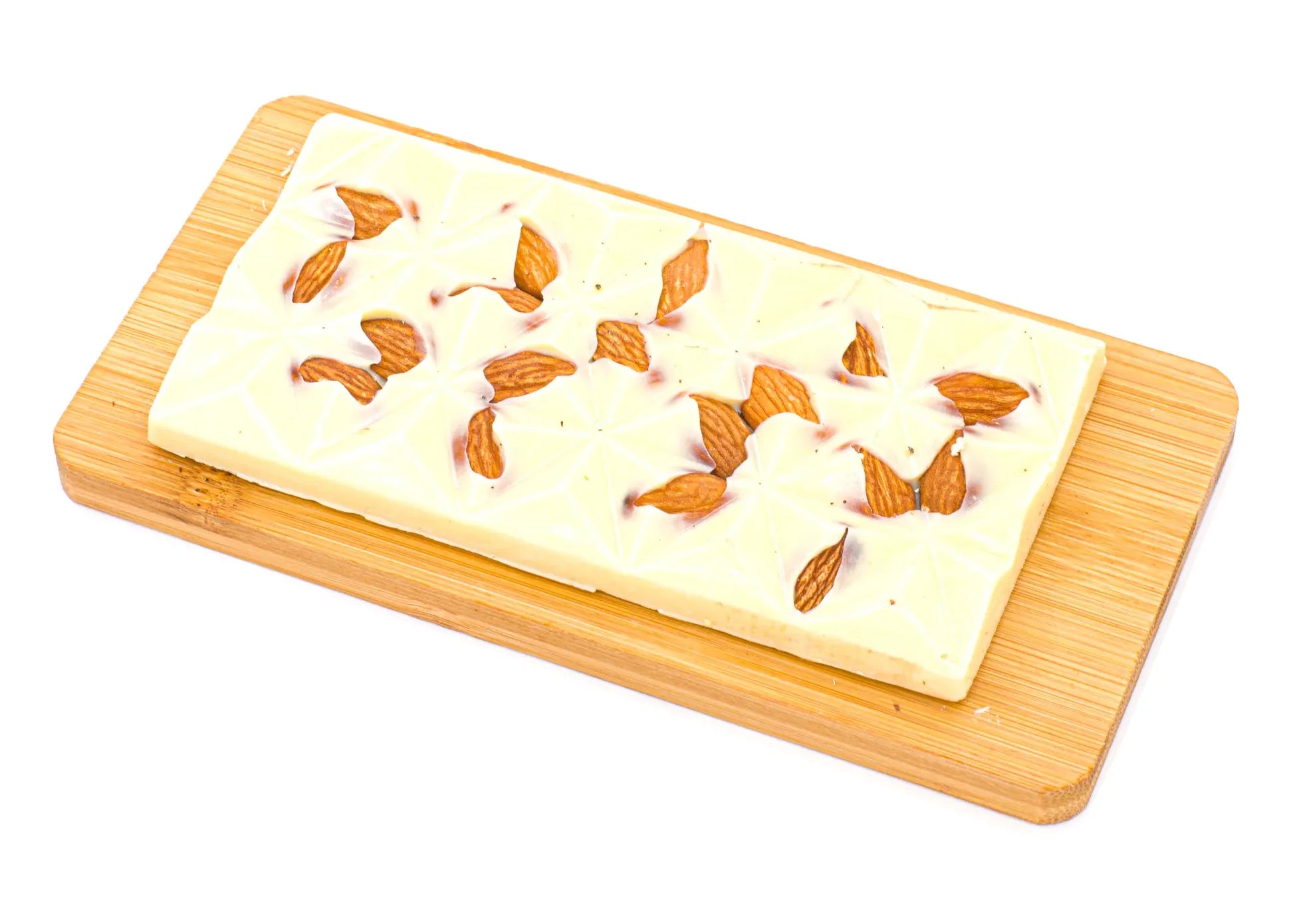 White chocolate bar with whole almonds on a wooden board, isolated on white background