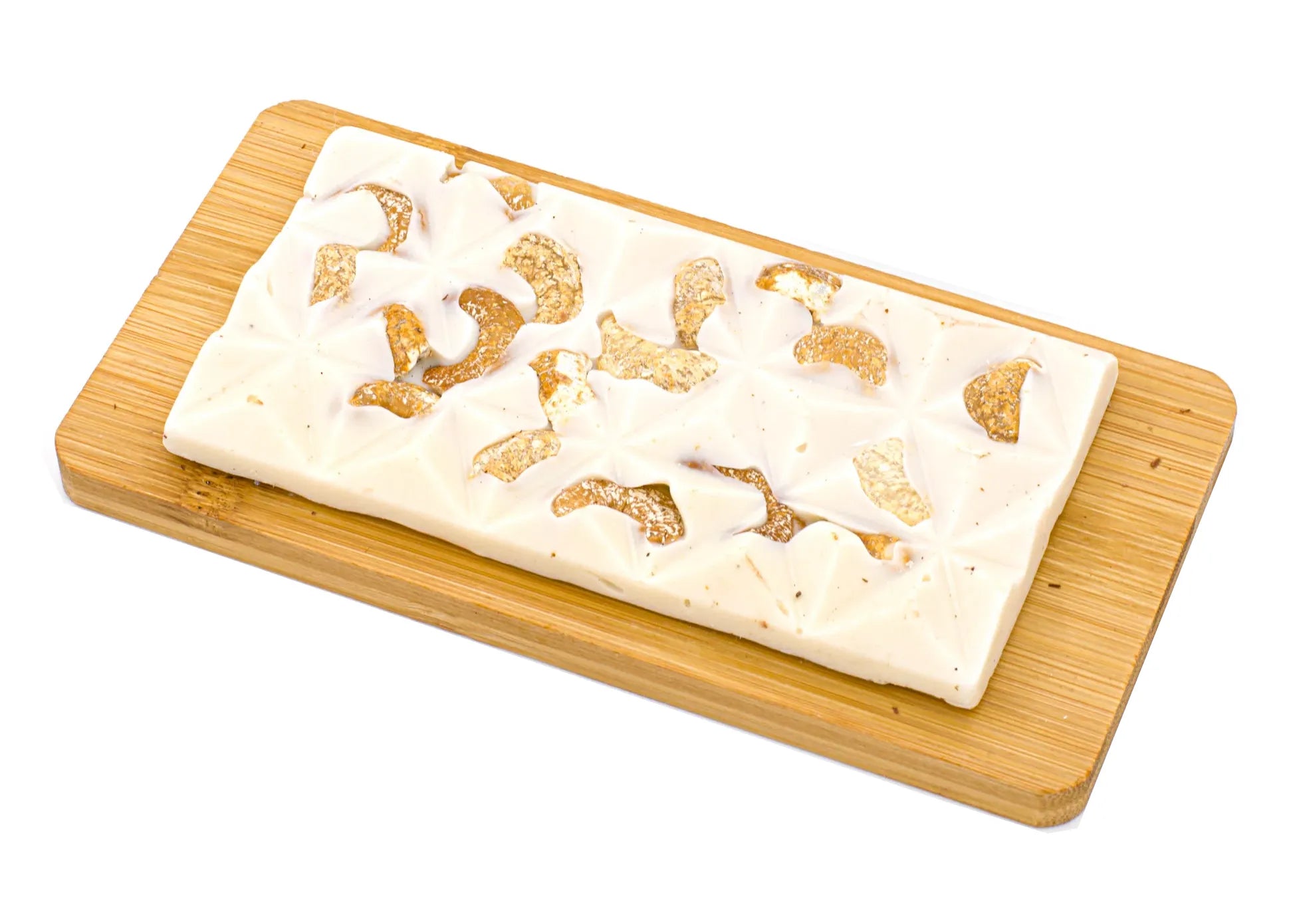White chocolate bar with cashew pieces on a wooden board