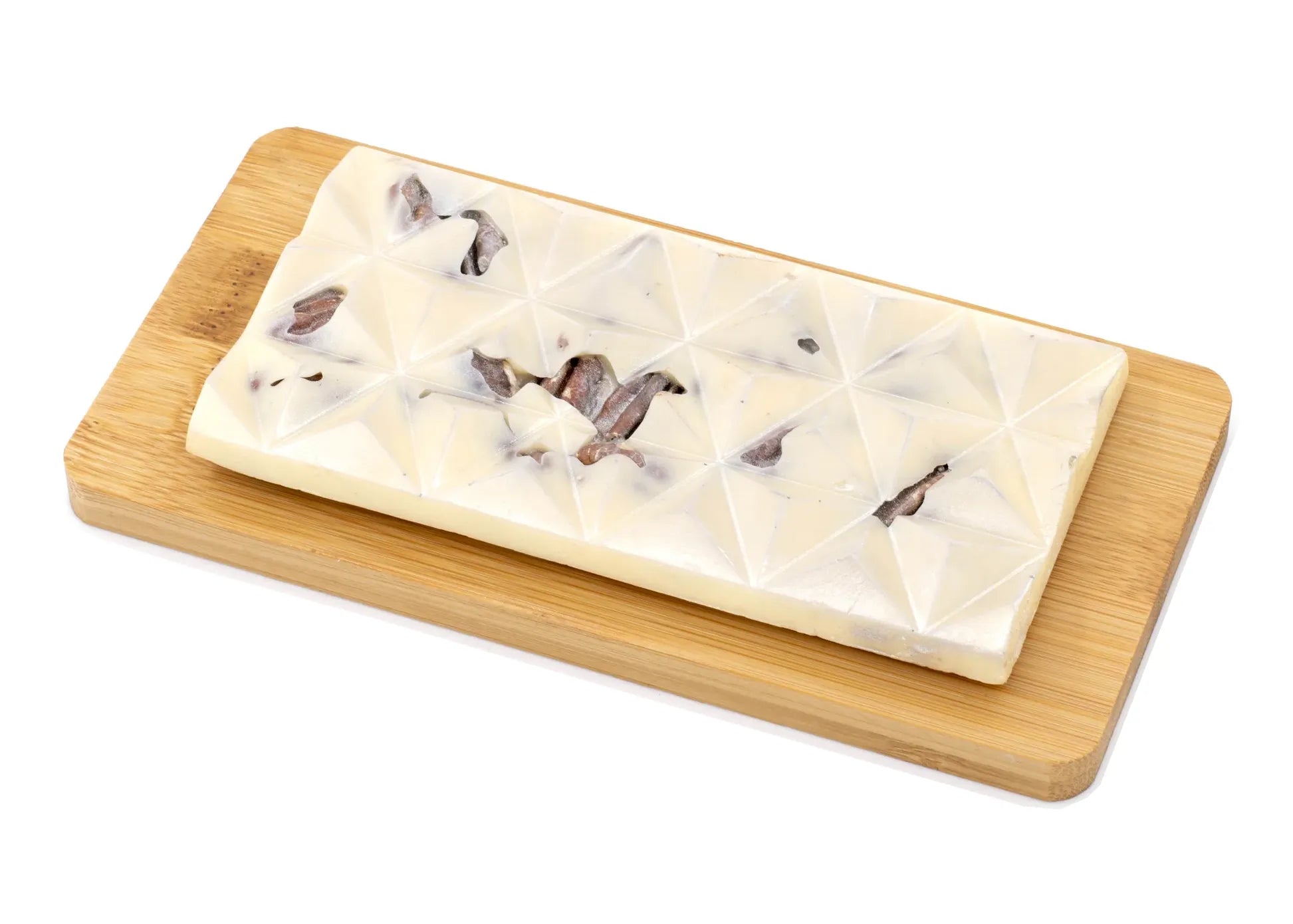 White chocolate bar with pecan pieces on a wooden board, gourmet chocolate dessert