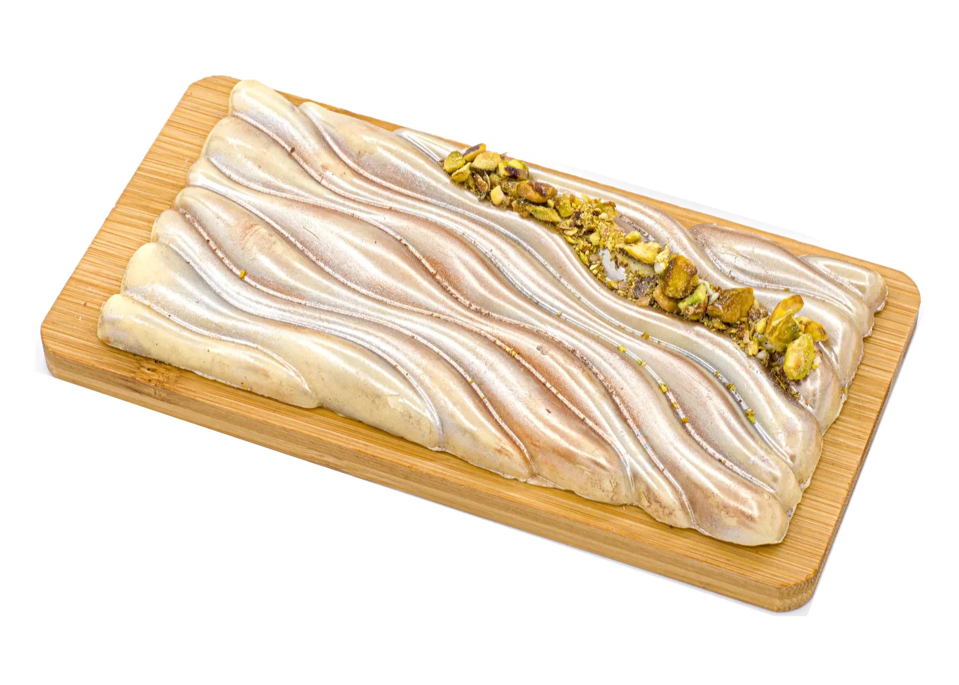 White chocolate bar with pistachio filling on a wooden board, metallic swirl design