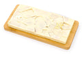 White chocolate bar with caramel and gold accents on a wooden board