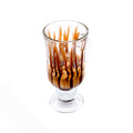 Glass of affogato dessert with chocolate drizzle and espresso over ice cream on white background